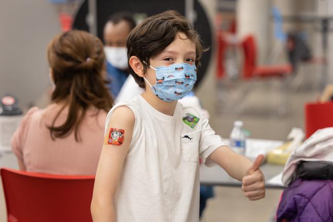 A child receives their vaccine at a catch-up clinic