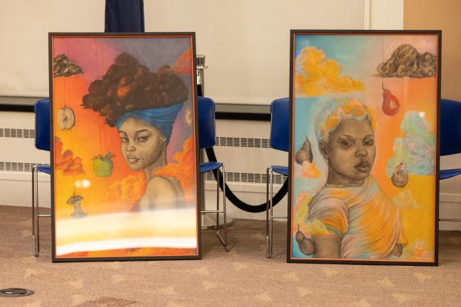 Two framed paintings on display in the boardroom