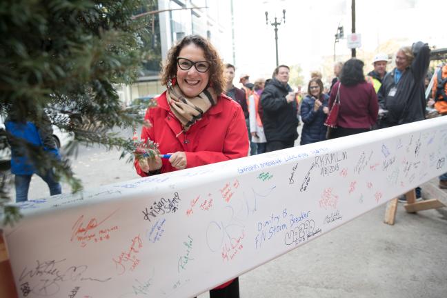 Commissioner Jessica Vega Pederson signs courthouse beam.