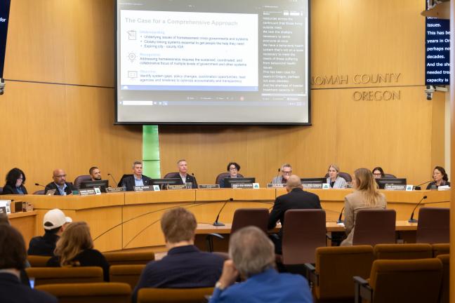 Both City and County elected officials sitting at the dais in the Multnomah County Boardroom under a projection screen.