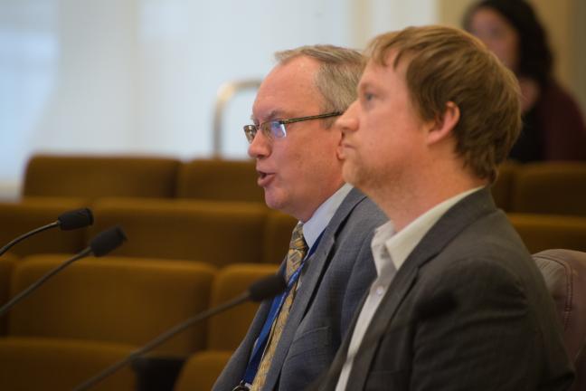 Multnomah County Courthouse Project Manager speaks to the board as Climate and Energy Coordinator Tim Lynch listens.