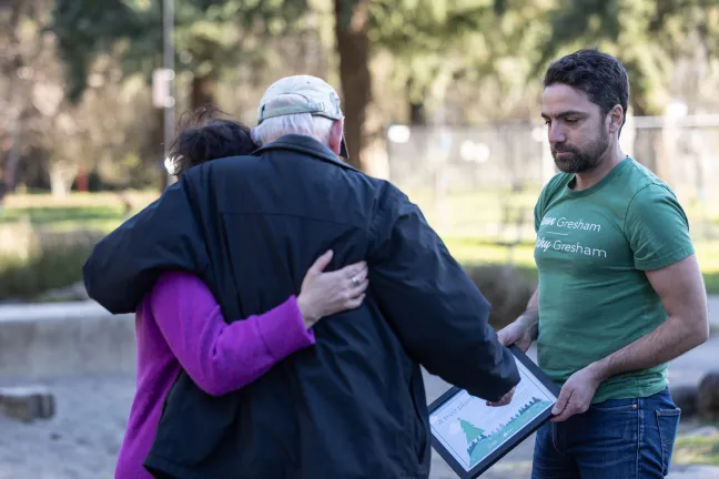 Image of Chair Vega Pederson hugging a family member in attendance at the tree planting ceremony