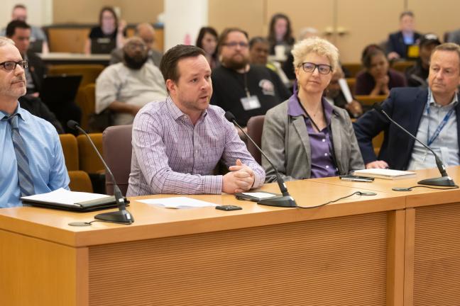 Four presenters from the Joint Office of Homeless Services sit at the dais in the boardroom.