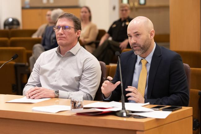 (Left to right): Aaron Lones, a project consultant, and Eric Zimmerman, Chief of Staff to Commissioner Julia Brim-Edwards, present details of the sobering center plan.