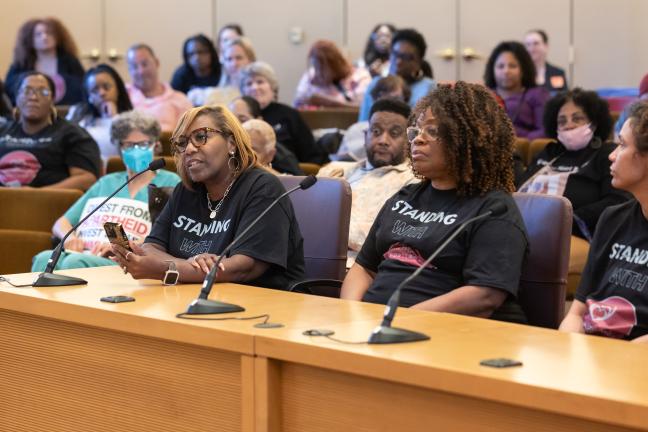 Three people sit at the dais in the Multnomah County boardroom