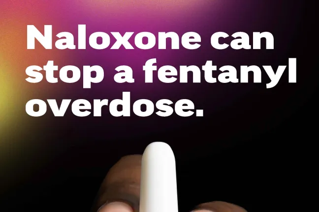 A hand holding naloxone with the text: Expect Fentanyl; Naloxone can stop an overdose; Protect your friends. Visit a student health center to get naloxone and learn how to use it. Or ask an adult you trust.