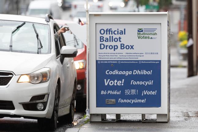 Voters line up in their vehicles to drop off ballots on Election Day in May 2024.