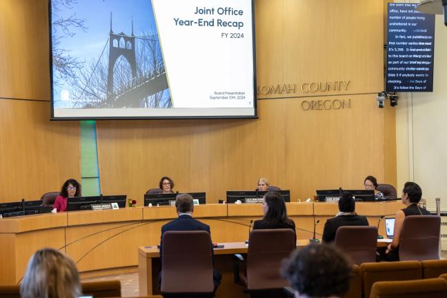 The Board of County Commissioners sit at the dais.