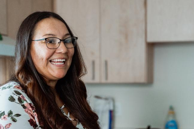 Woman smiles in a kitchen