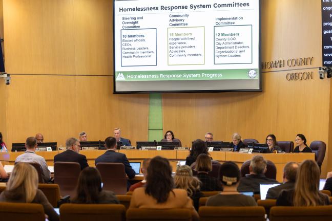 The County Board of Commissioners and Portland City Council sits at the dais in the Multnomah County boardroom.