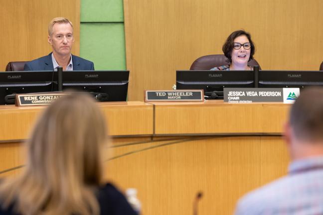 Mayor Ted Wheeler and Chair Jessica Vega Pederson sit at the dais