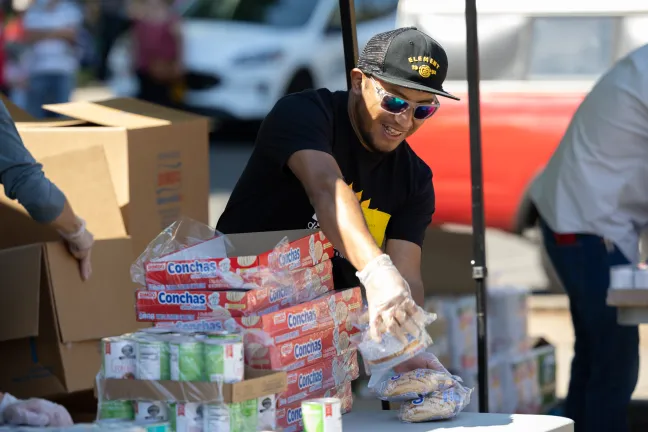 Bienestar de la Familia staff organizing food for a food bank