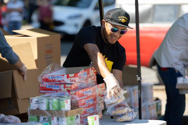 Bienestar de la Familia staff organizing food for a food bank