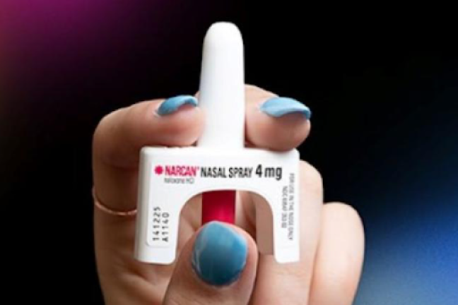 Hand holding a bottle of Narcan nasal spray