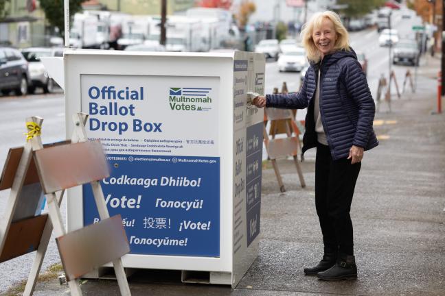 A voter uses a ballot box near the Multnomah County Duniway-Lovejoy Elections Building in October 2024.