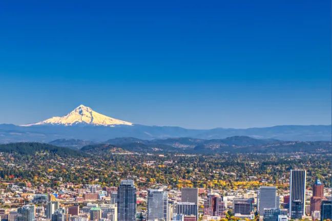 A wide angle view of Multnomah County featuring Mt Hood in the back ground and downtown Portland in the foreground.