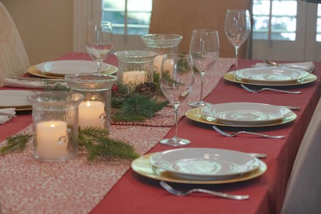 Holiday table setting with red tablecloth 