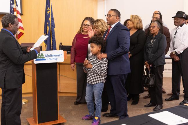 Commissioner Vince Jones-Dixon is sworn in by Emmanuel McFadden Jr. on Jan. 6, 2025, in the Multnomah County Boardroom.