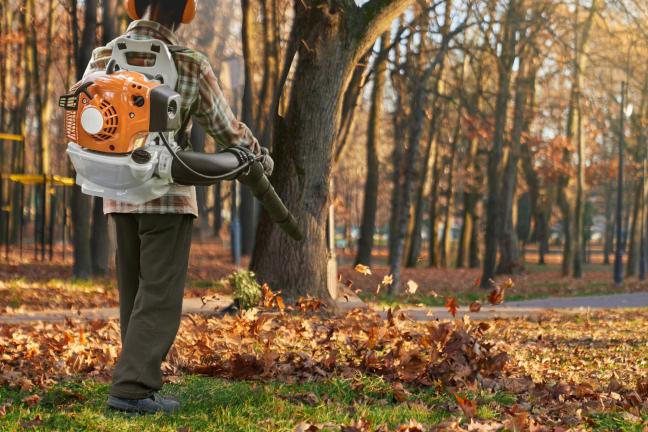 man operating a gas-powered leaf blower