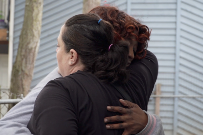 Adele hugging a woman