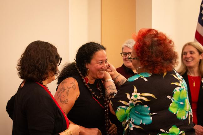 Kimberly Dixon puts a beaded garland on Commissioner Shannon Singleton