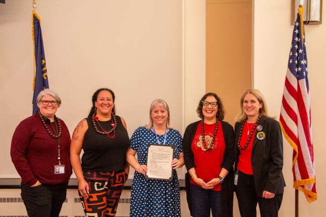 Kelli Gallippi stands with members of the Board of County Commissioners.