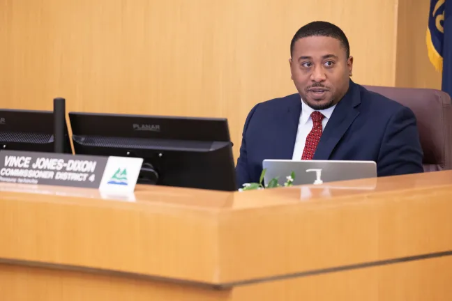 Commissioner Vince Jones-Dixon sits behind the dais during the June 12, 2025, board meeting.