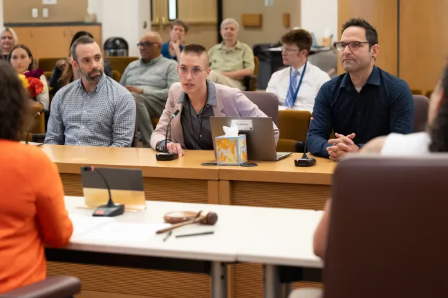 Steve Richard, Kat Stevens and Jacob Mestman sit at the dais in the Multnomah County Boardroom