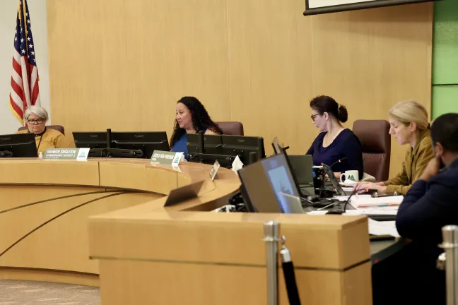 The Board of County Commissioners sit at the dais in the boardroom.