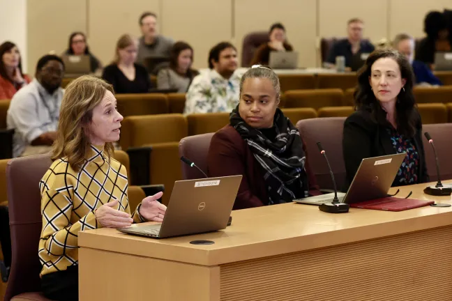 Christian Elkin, Antoinette Payne and Anna Plumb sit at dais.