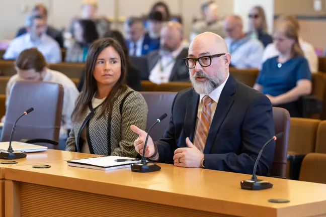 Deputy Chief Operating Officer Sara Morrissey and Homeless Services Director Nathaniel VerGow sit at the dais.