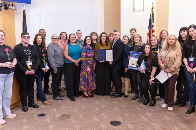 Board of Commissioners joined by invited guests pose for a photo