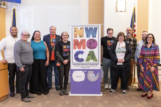  Presenters and members of the board pose for Superhero Month in Multnomah County. 