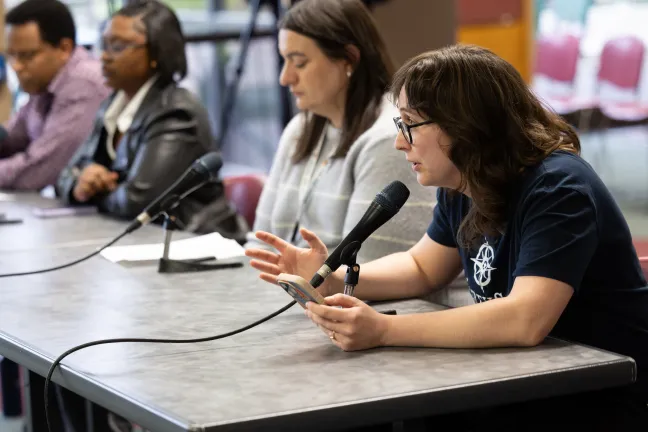 Community members sit before the board and testify for the public budget hearing 
