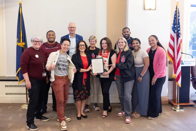 Board members and invited guests pose with the signed 503 Day proclamation in the boardroom.