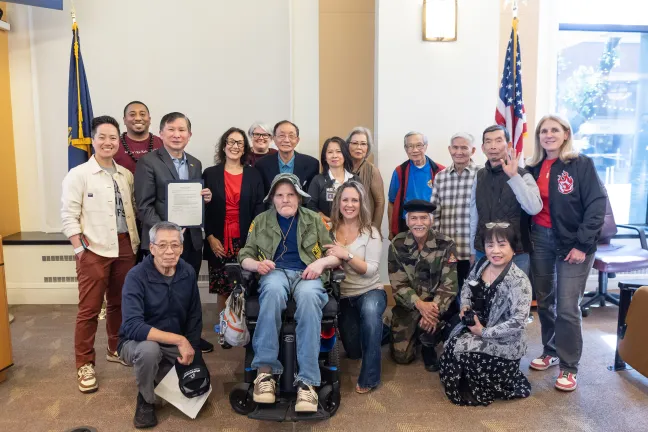 Board members, County staff and invited guests pose with the signed Vietnamese-American Remembrance Day proclamation in the boardroom.