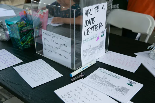 a small bin labeled "Write a Love Letter" surrounded by pens and cards