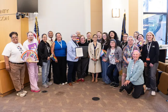  Community members and County leaders gather for a photo to celebrate the signing of the Pride Month Proclamation. 