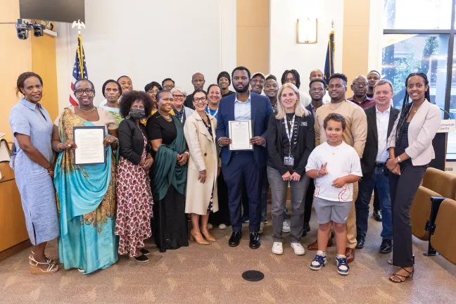 The Board and community members pose for a photo in the board room during the Day of Reflection on the 1944 Genocide against the Tutsi in Rwanda Proclamation signing. 