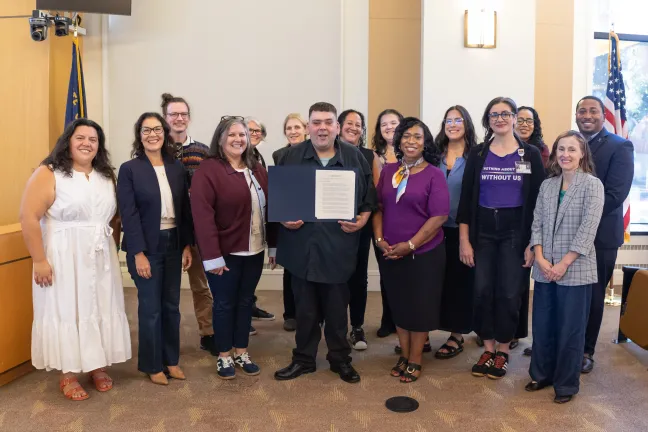 The Board, County staff and community members pose for a photo with the National Disability Employment Awareness Month proclamation.