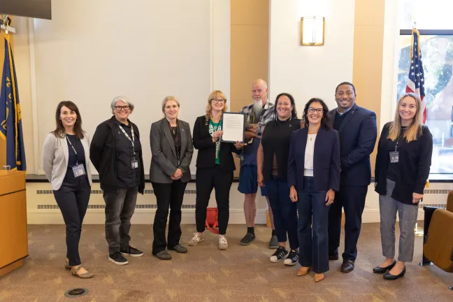 The Board and County staff pose for a photo with the Oregon Archives Month proclamation.
