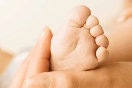 mom holding a baby's foot