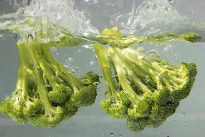 fresh broccoli dunked in water