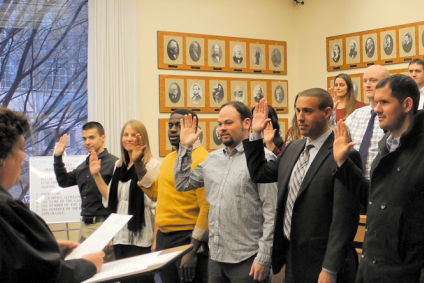 Group of adults raising their right hands