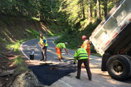 County road crew patches pavement on Larch Mountain Road after a culvert repair.