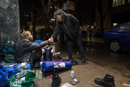 JOIN outreach worker shakes hand with man on the street in Portland.