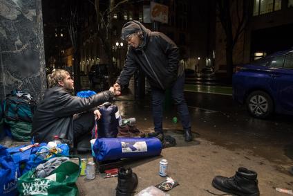 JOIN outreach worker shakes hand with man on the street in Portland.