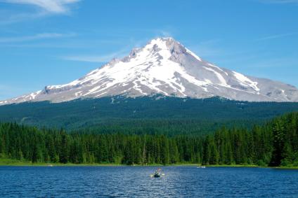 Two people in a canoe on Trillium Lake in front of Mt. Hood
