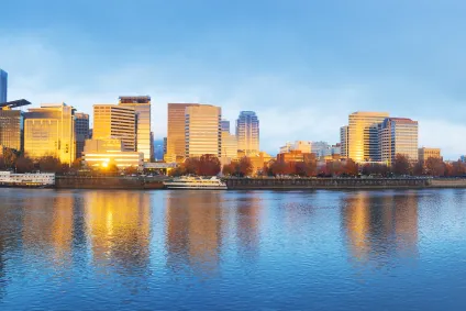 Cityscape of Portland Oregon as the sun rises over the Willamette River