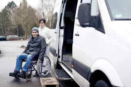 community partner assists older adult with transportation service